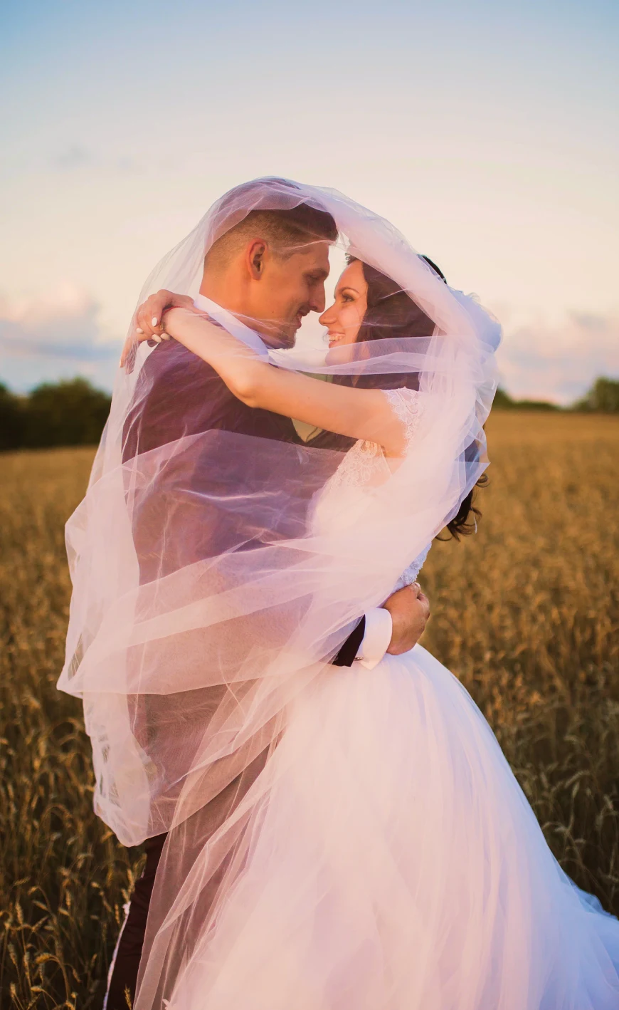 the bride and groom embrace