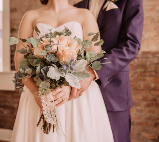 the bride with flowers and the groom next to her