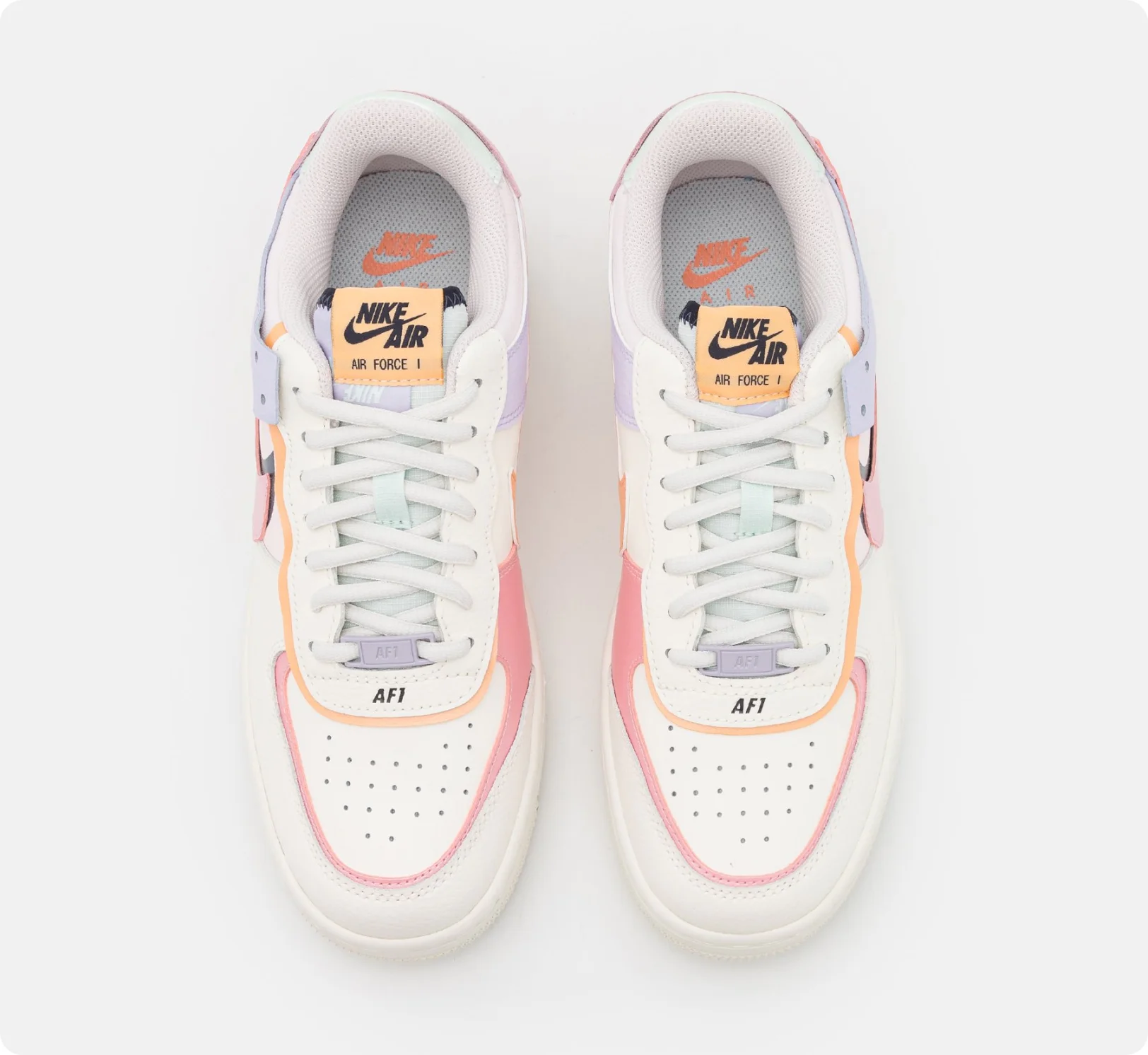 white sneakers with pink and blue inserts, top view