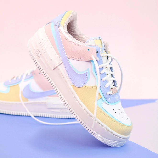 multi-colored sneakers on a pink-blue background