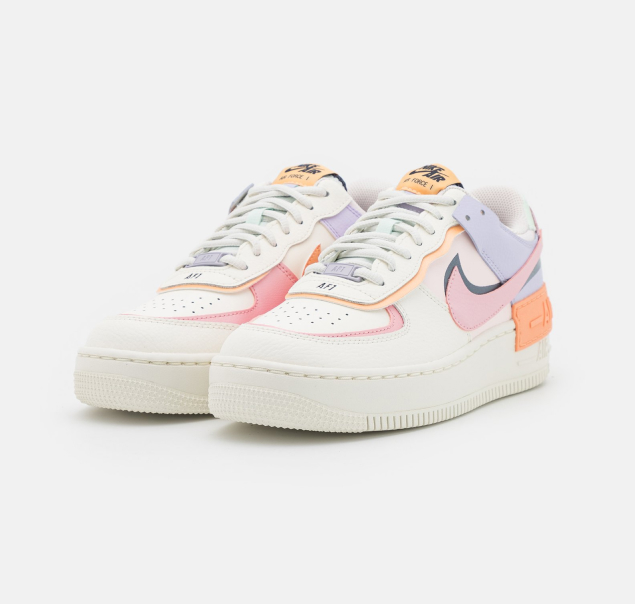 white sneakers with pink, orange and blue accents