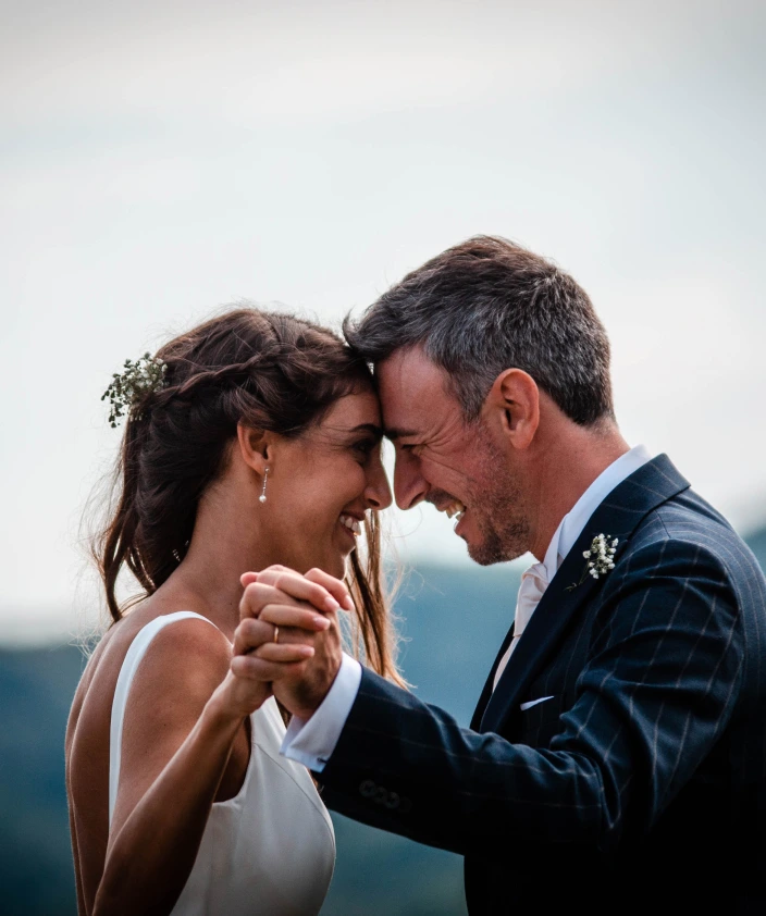 the bride and groom are smiling