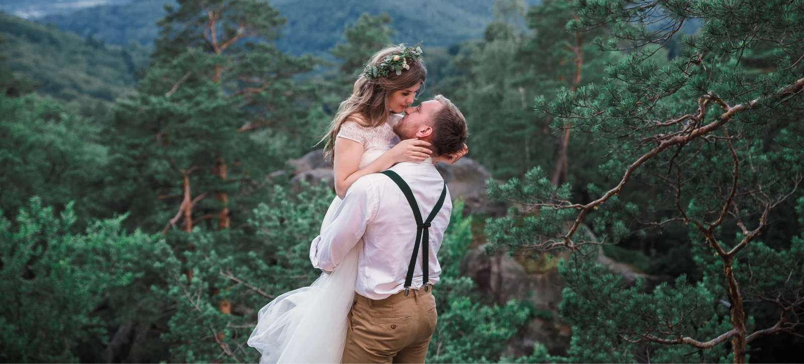 The groom holds the bride in his arms