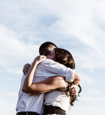 girl and boy hugging