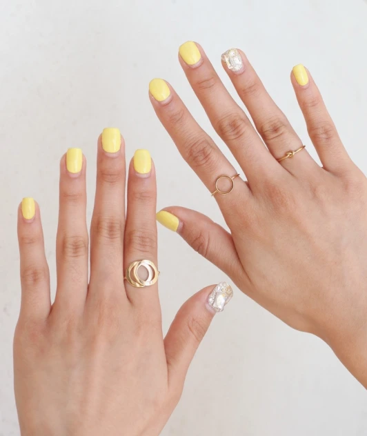 a girl with a yellow manicure