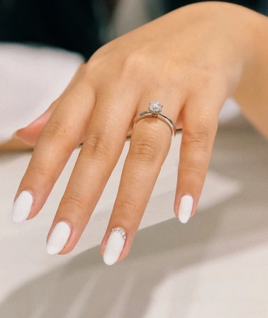 a girl with a white manicure