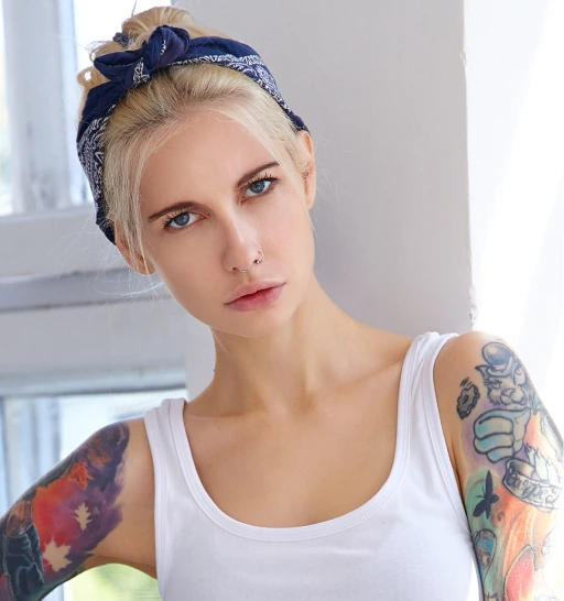 a girl in a white T-shirt with a tattoo