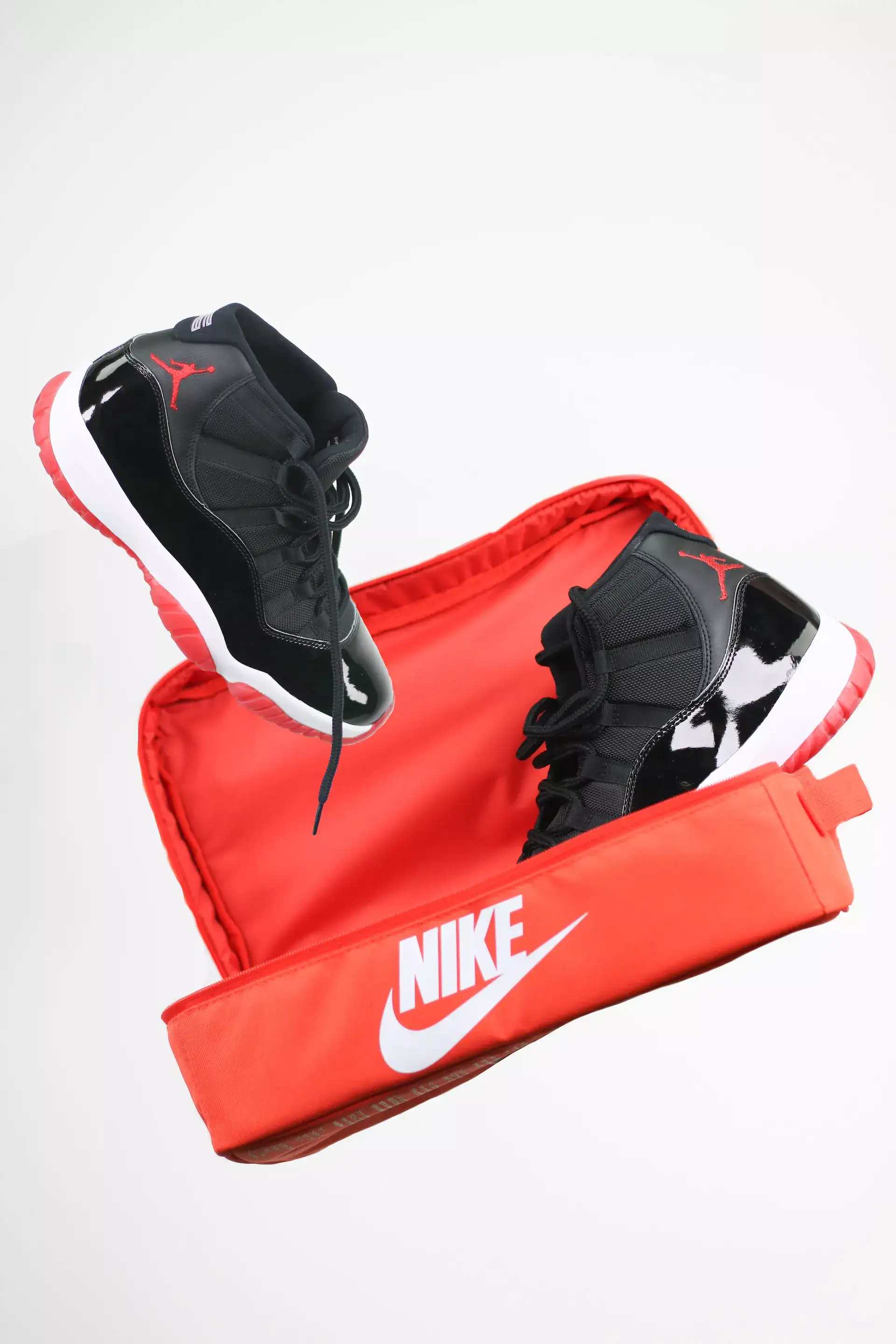 black basketball shoes with red packaging