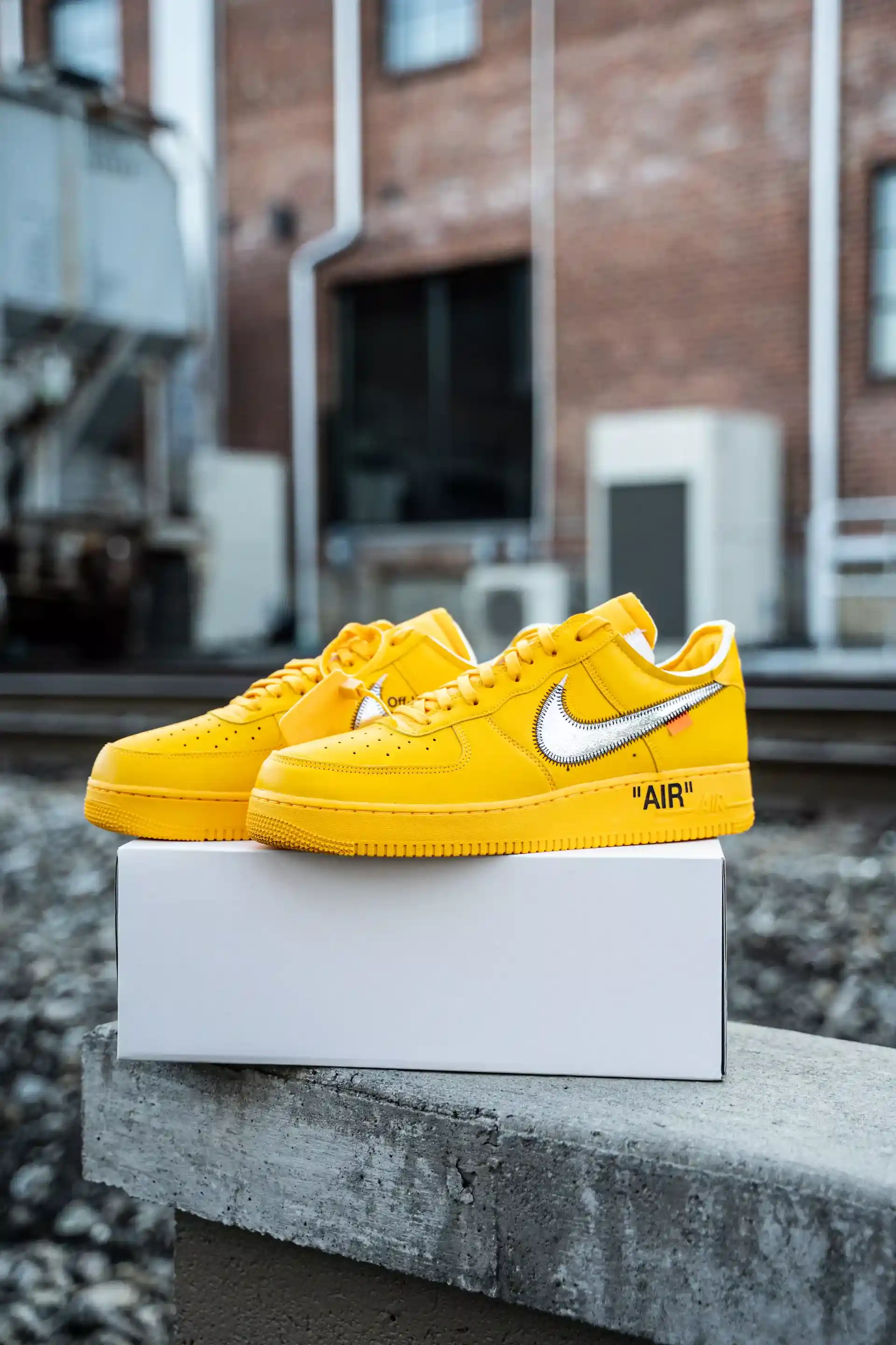 bright yellow sneakers with a white sign