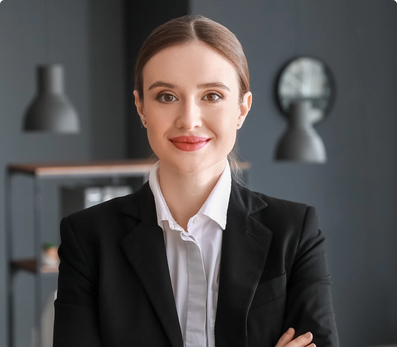 a girl with tied dark hair in a formal suit folded her arms over her chest