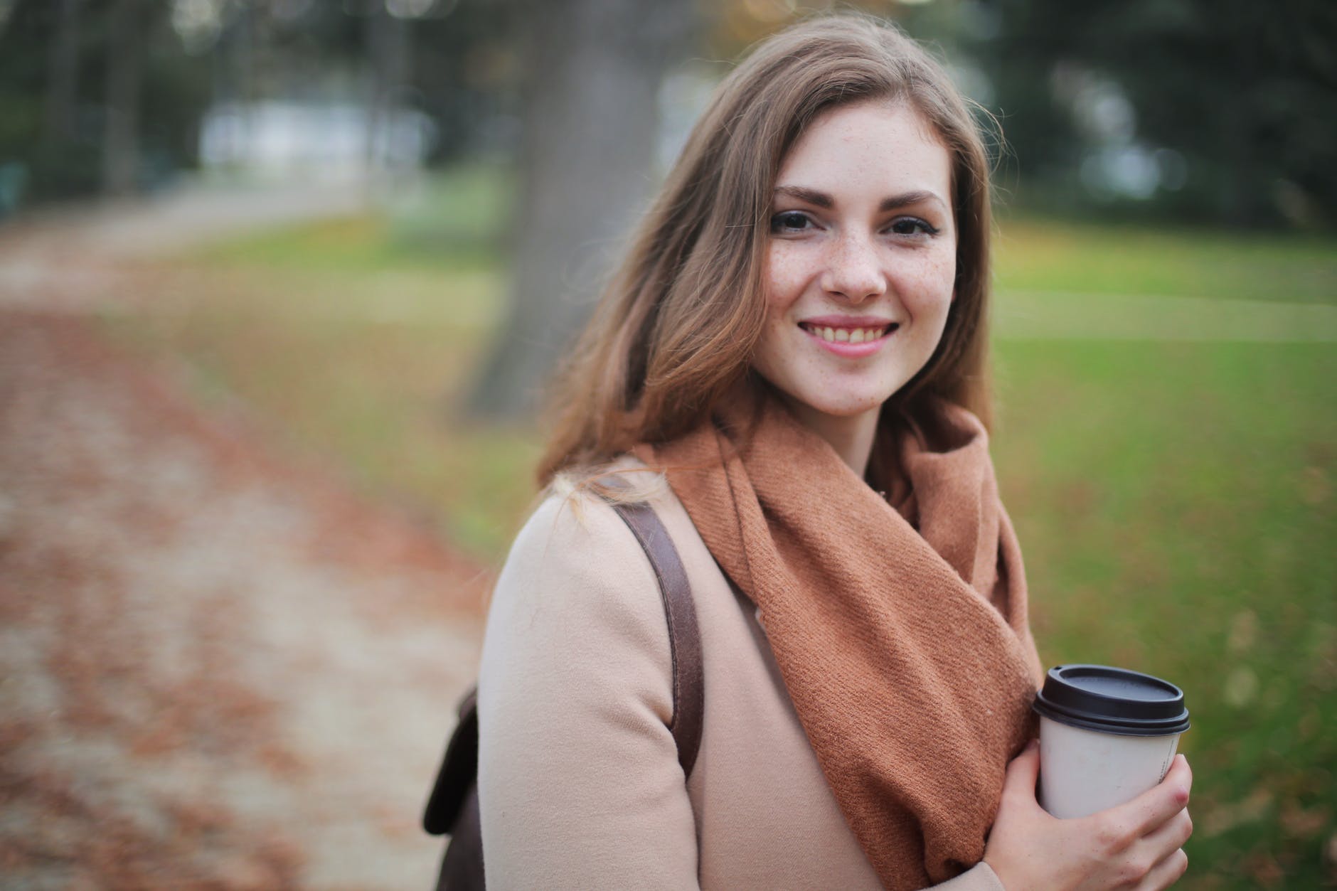 Smiling women with coffee during autumn
