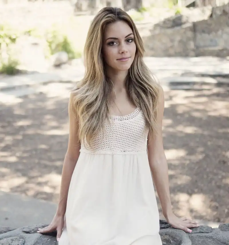 a girl with blond hair in a light dress