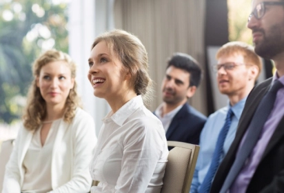 room of business advisors laughing at a joke