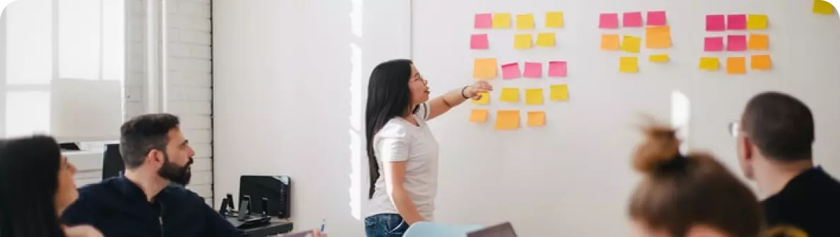 the girl looks at the stickers on the board